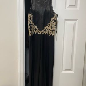 Black gown with gold on top. Worn once. Great condition.